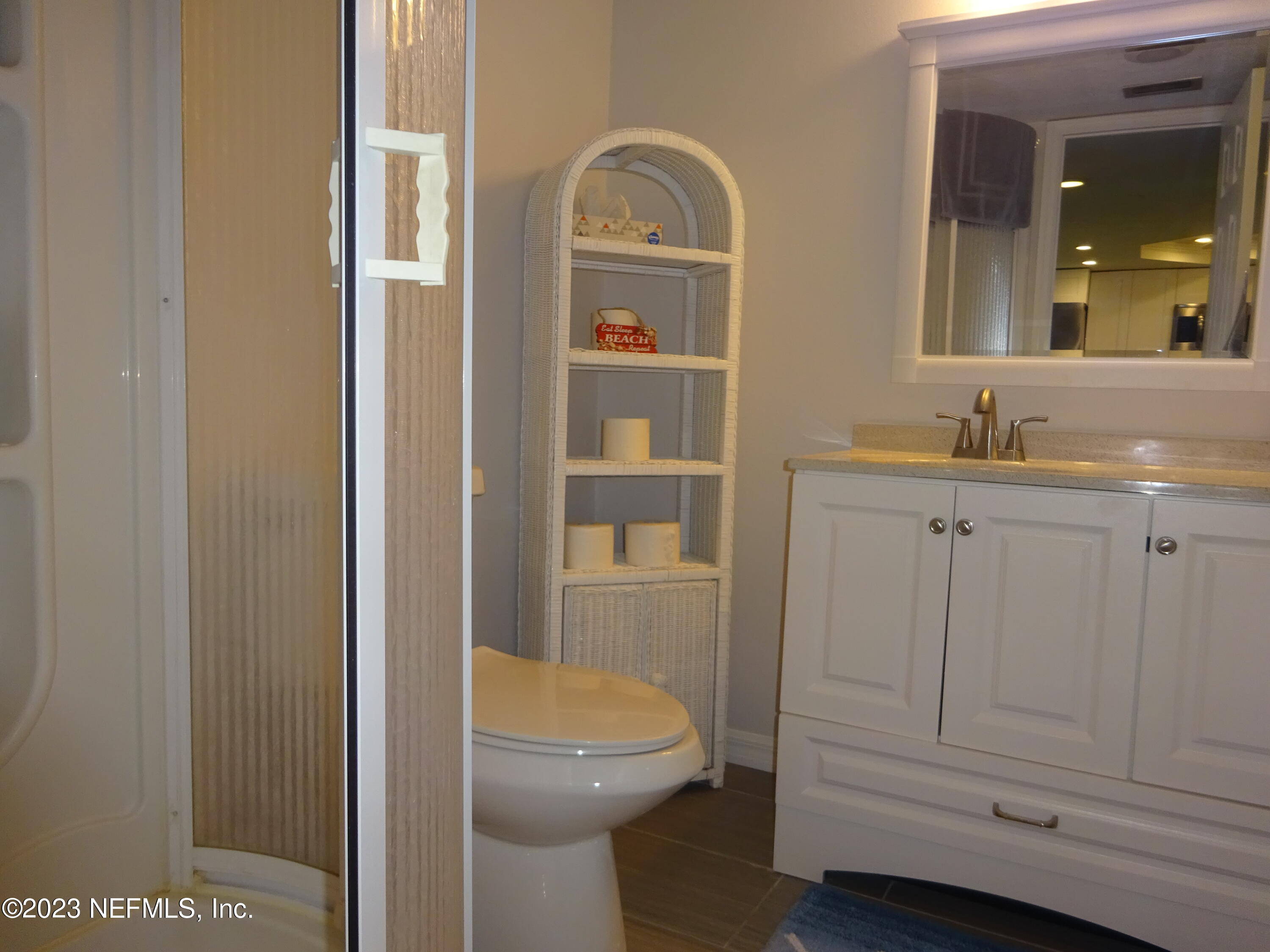 7175 A1A South, Unit F141 St. Augustine, FL 32080 - Photo 16 of 36 a bathroom with a toilet a sink and mirror