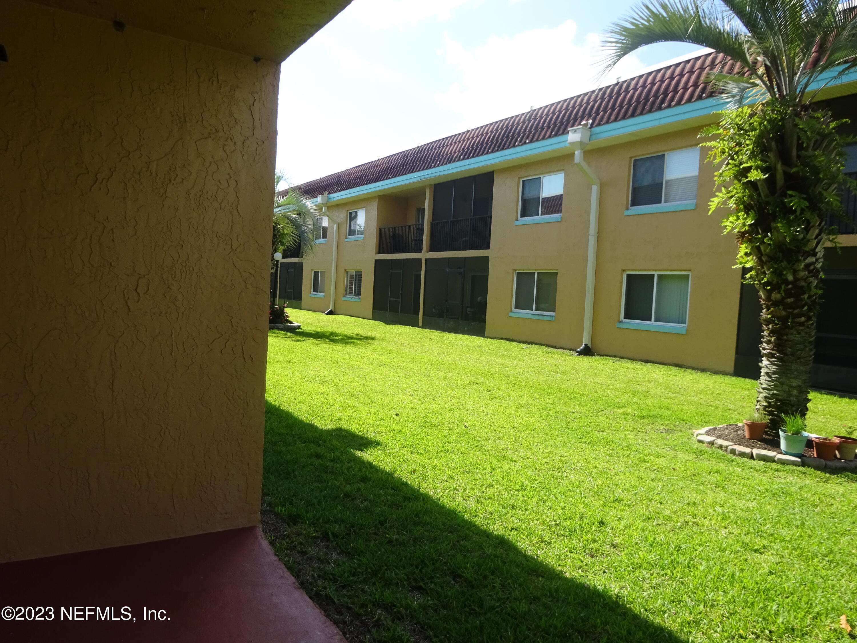 7175 A1A South, Unit F141 St. Augustine, FL 32080 - Photo 19 of 36 a view of an house with backyard space and garden