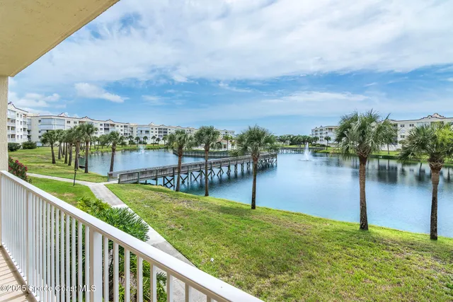 a view of a lake with houses in the back