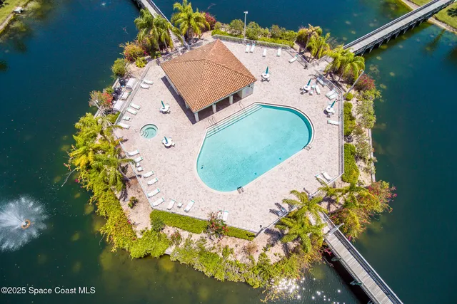 an aerial view of a house with swimming pool and outdoor space