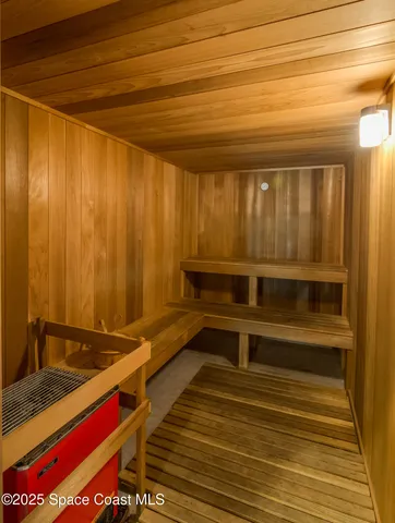a utility room with wooden floor and furniture