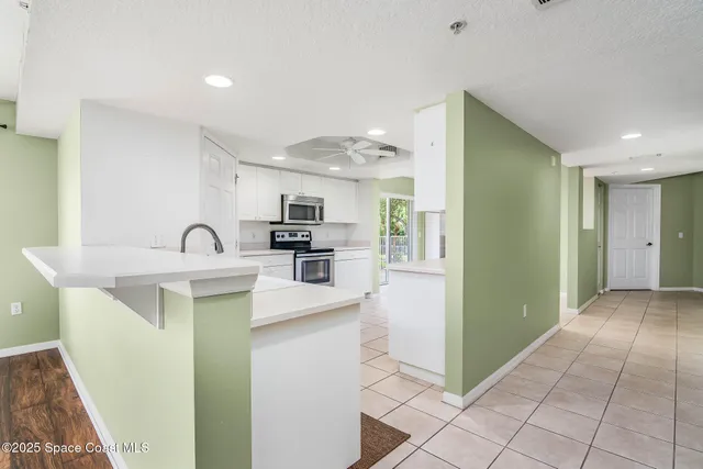 a kitchen with stainless steel appliances granite countertop a sink and a refrigerator