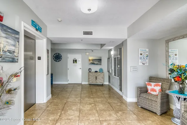 a view of a hallway to room with furniture and toys
