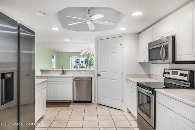 a kitchen with a stove a sink and a refrigerator