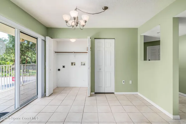 a view of a chandelier fan and entryway