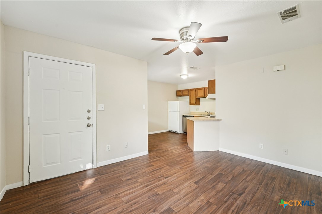 1634 Post Road, Unit 4 San Marcos, TX 78666 - Photo 5 of 11 a view of empty room with wooden floor