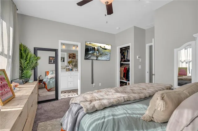 a bedroom with a large bed and a window