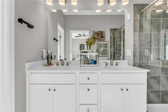 a bathroom with a sink vanity granite and a mirror