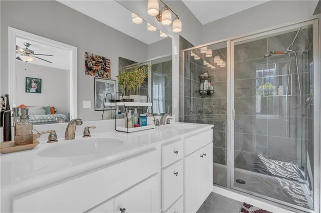 a bathroom with a shower sink and mirror