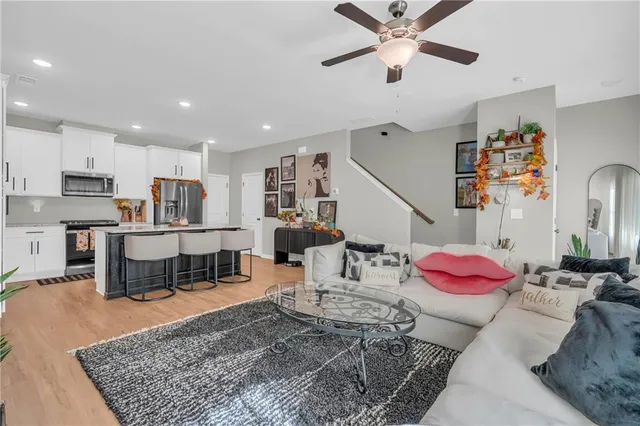 a living room with furniture and kitchen view