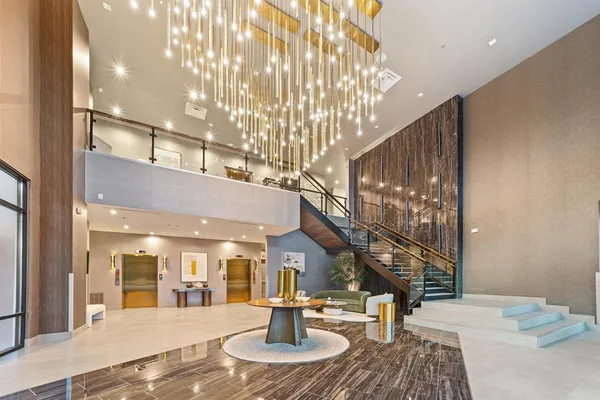 a lobby with furniture and a chandelier