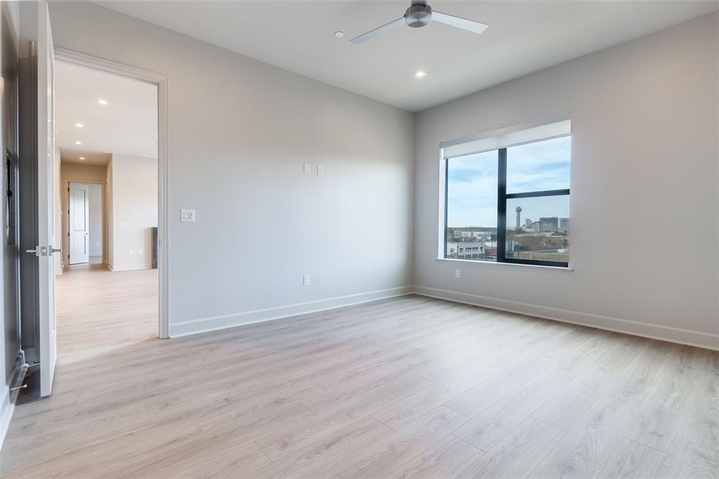 1900 South Ervay Street, Unit 512 Dallas, TX 75215 - Photo 13 of 22 an empty room with wooden floor chandelier and windows