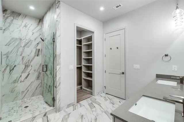 a view of a bathroom with a bathtub and shower