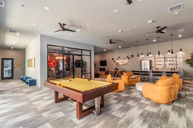 a living room with dining room and wooden floor