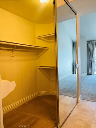 a view of walk in closet with empty room