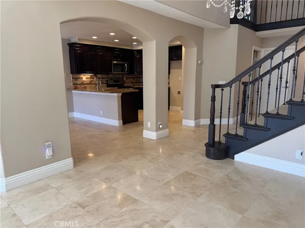 a view of a hallway with entryway and kitchen view