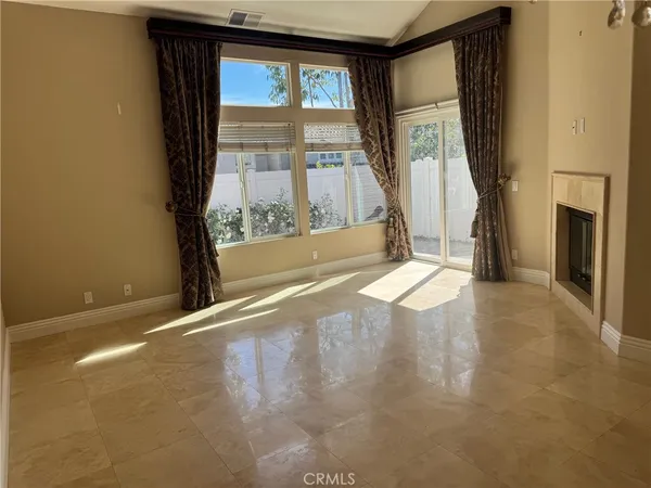 a view of a room with a fireplace and windows