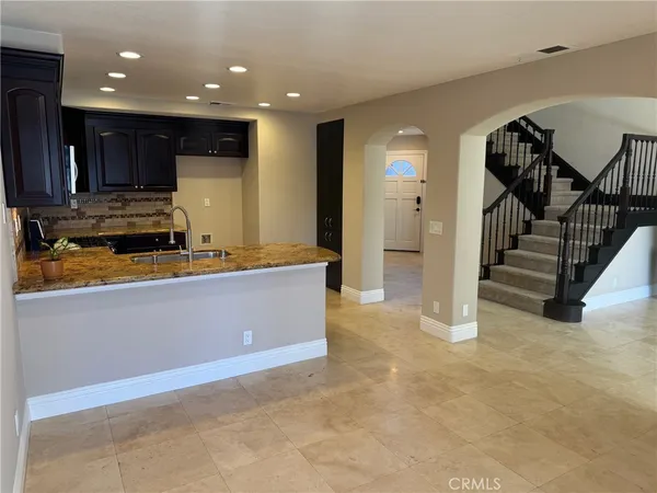 a view of kitchen with refrigerator and a counter top