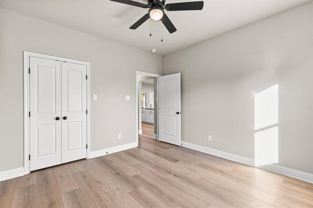 2913 Mildred Street Waco, TX 76706 - Photo 23 of 33 Unfurnished bedroom featuring light wood finished floors, a ceiling fan, and a closet