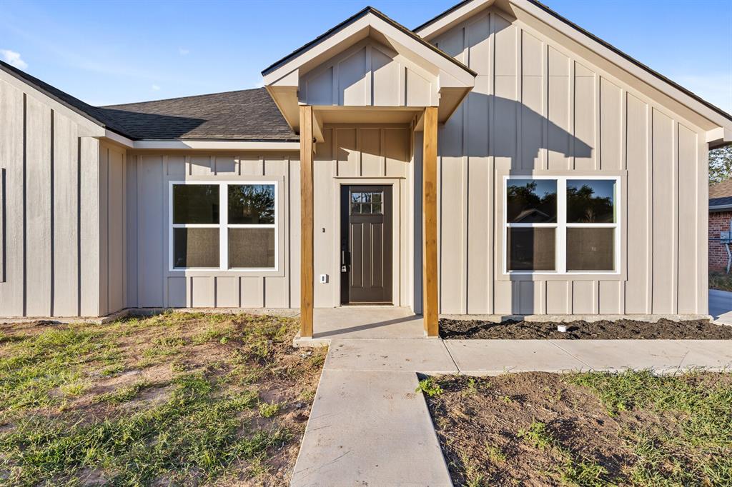 2913 Mildred Street Waco, TX 76706 - Photo 5 of 33 Doorway to property featuring board and batten siding and roof with shingles