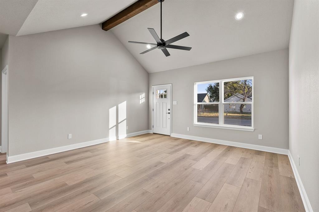 2913 Mildred Street Waco, TX 76706 - Photo 6 of 33 Unfurnished living room featuring beam ceiling, ceiling fan, high vaulted ceiling, recessed lighting, and light wood-type flooring