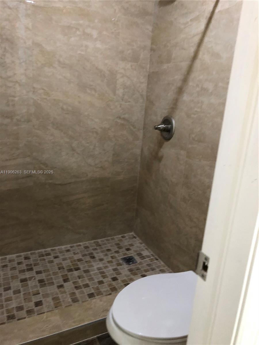 15065 Southwest 49th Lane, Unit E109 Miami, FL 33185 - Photo 11 of 21 a bathroom with a toilet and a shower
