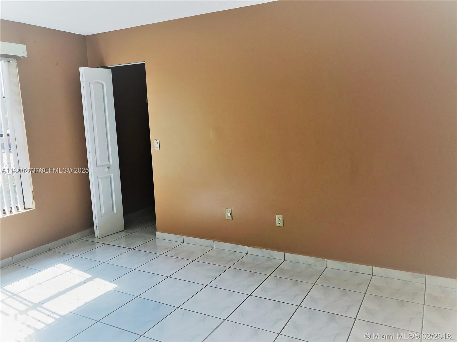 15065 Southwest 49th Lane, Unit E109 Miami, FL 33185 - Photo 12 of 21 an empty room with windows