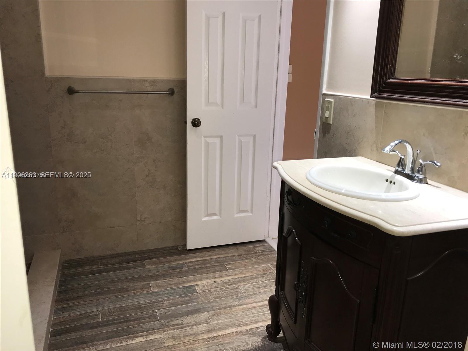 15065 Southwest 49th Lane, Unit E109 Miami, FL 33185 - Photo 15 of 21 a bathroom with a sink and a mirror