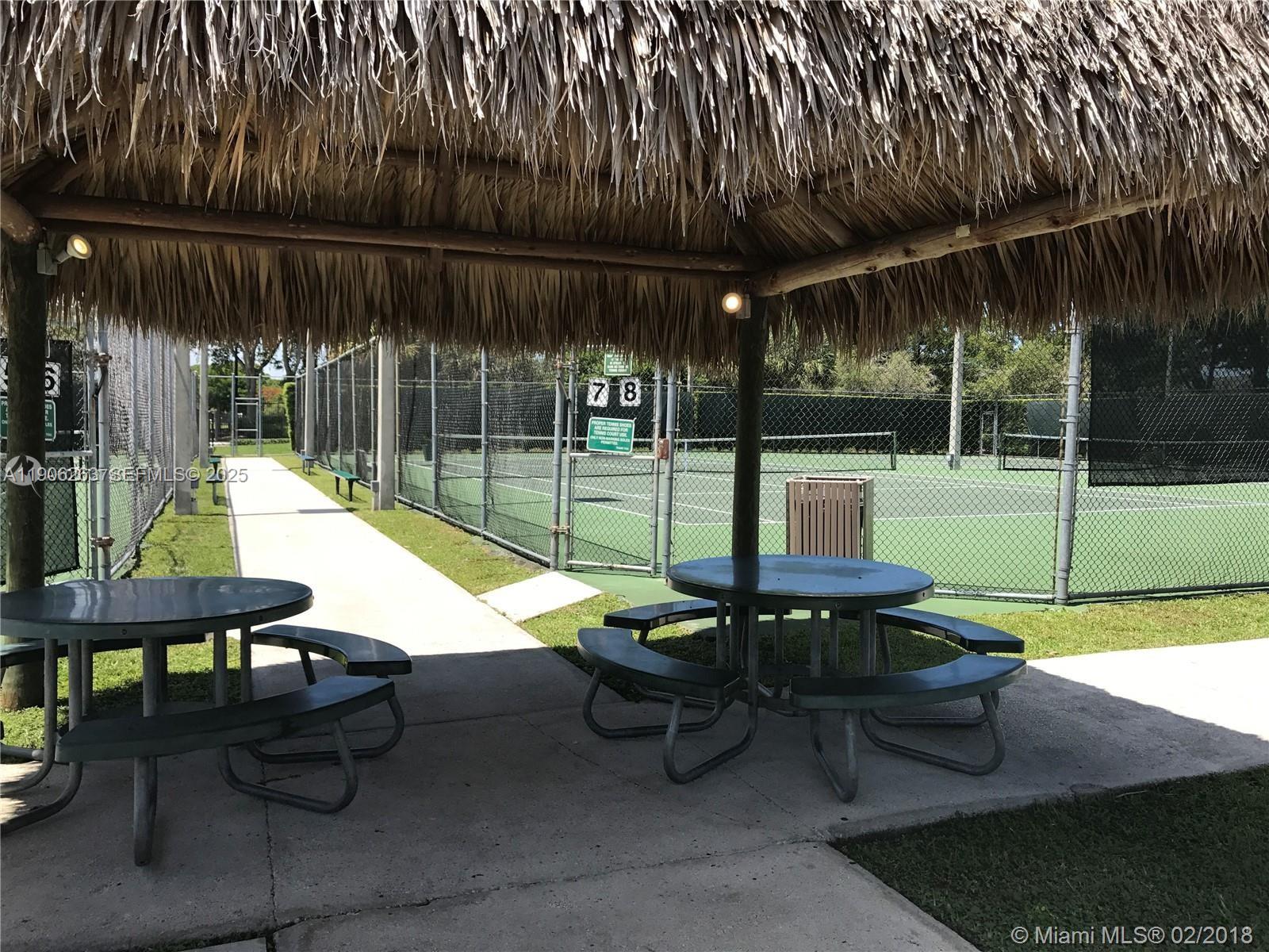 15065 Southwest 49th Lane, Unit E109 Miami, FL 33185 - Photo 19 of 21 a view of a backyard with swimming pool and sitting area