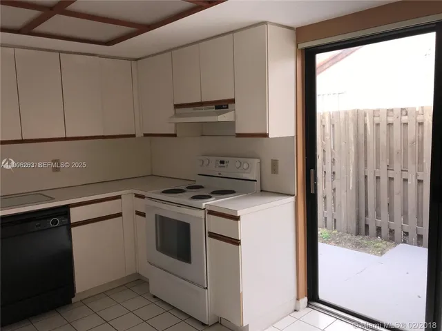 a kitchen with a stove a sink and a refrigerator