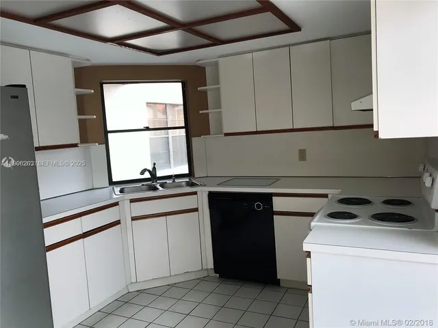 a kitchen with appliances cabinets and a sink