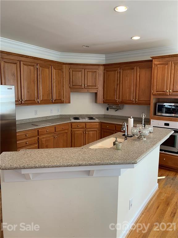 3081 River Bend Drive Tega Cay, SC 29708 - Photo 4 of 15 a kitchen with stainless steel appliances granite countertop a sink a stove and a refrigerator