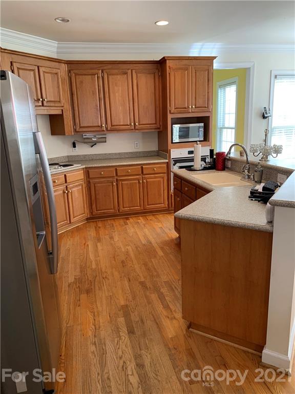 3081 River Bend Drive Tega Cay, SC 29708 - Photo 5 of 15 a kitchen with stainless steel appliances a refrigerator sink and cabinets