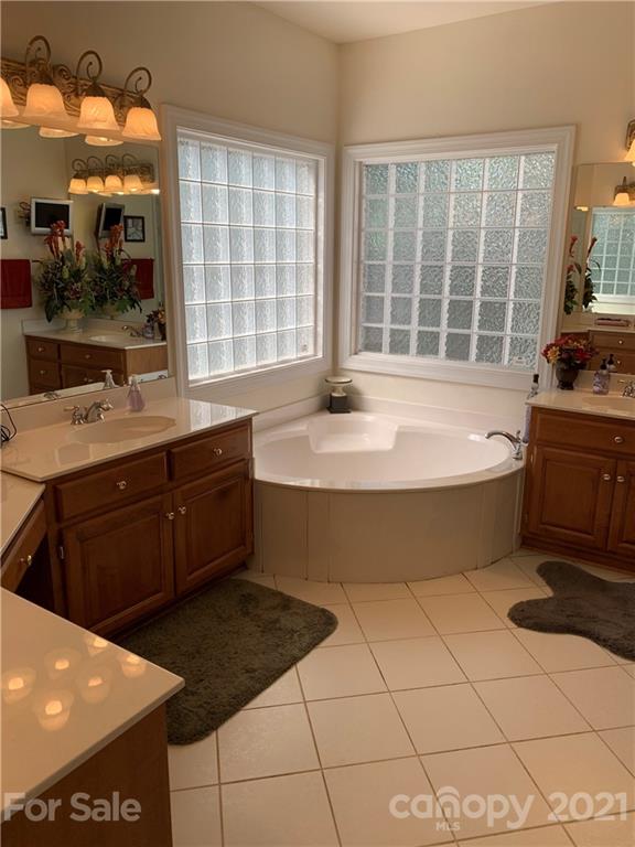 3081 River Bend Drive Tega Cay, SC 29708 - Photo 9 of 15 a spacious bathroom with a tub sink and mirror