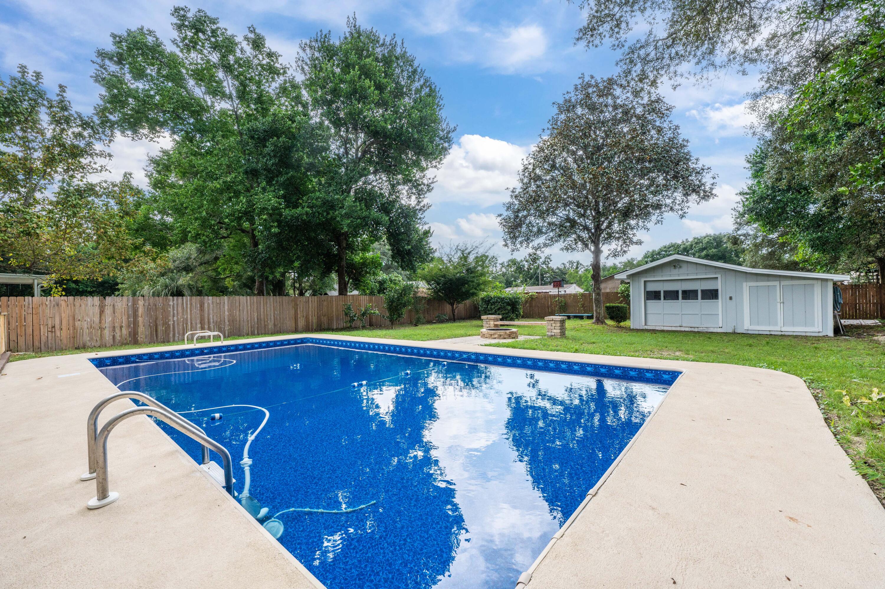 413 Gerold Street Fort Walton Beach, FL 32547 - Photo 1 of 91 a view of a swimming pool with a yard