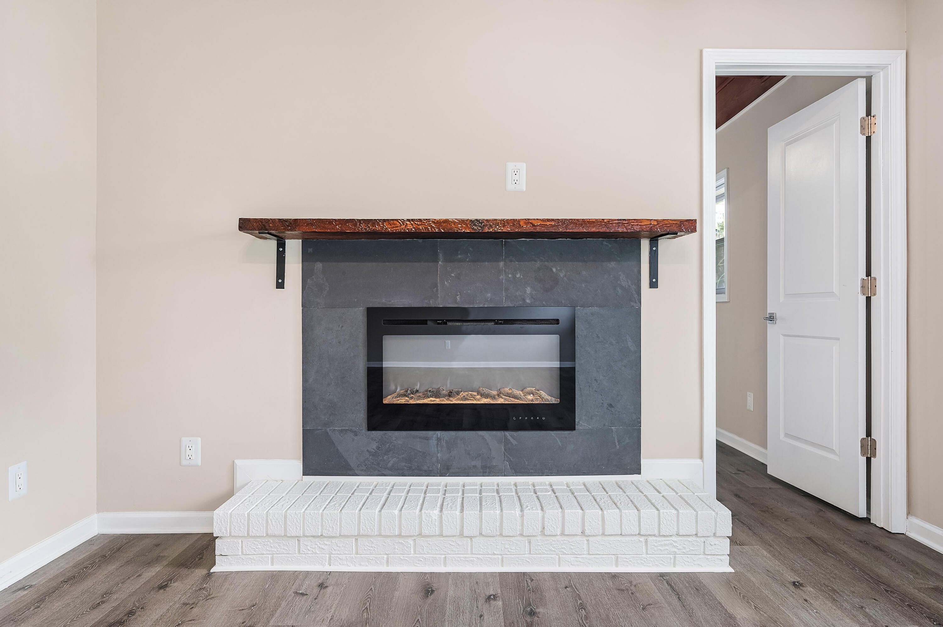 413 Gerold Street Fort Walton Beach, FL 32547 - Photo 12 of 91 a living room with a fireplace and wooden floor