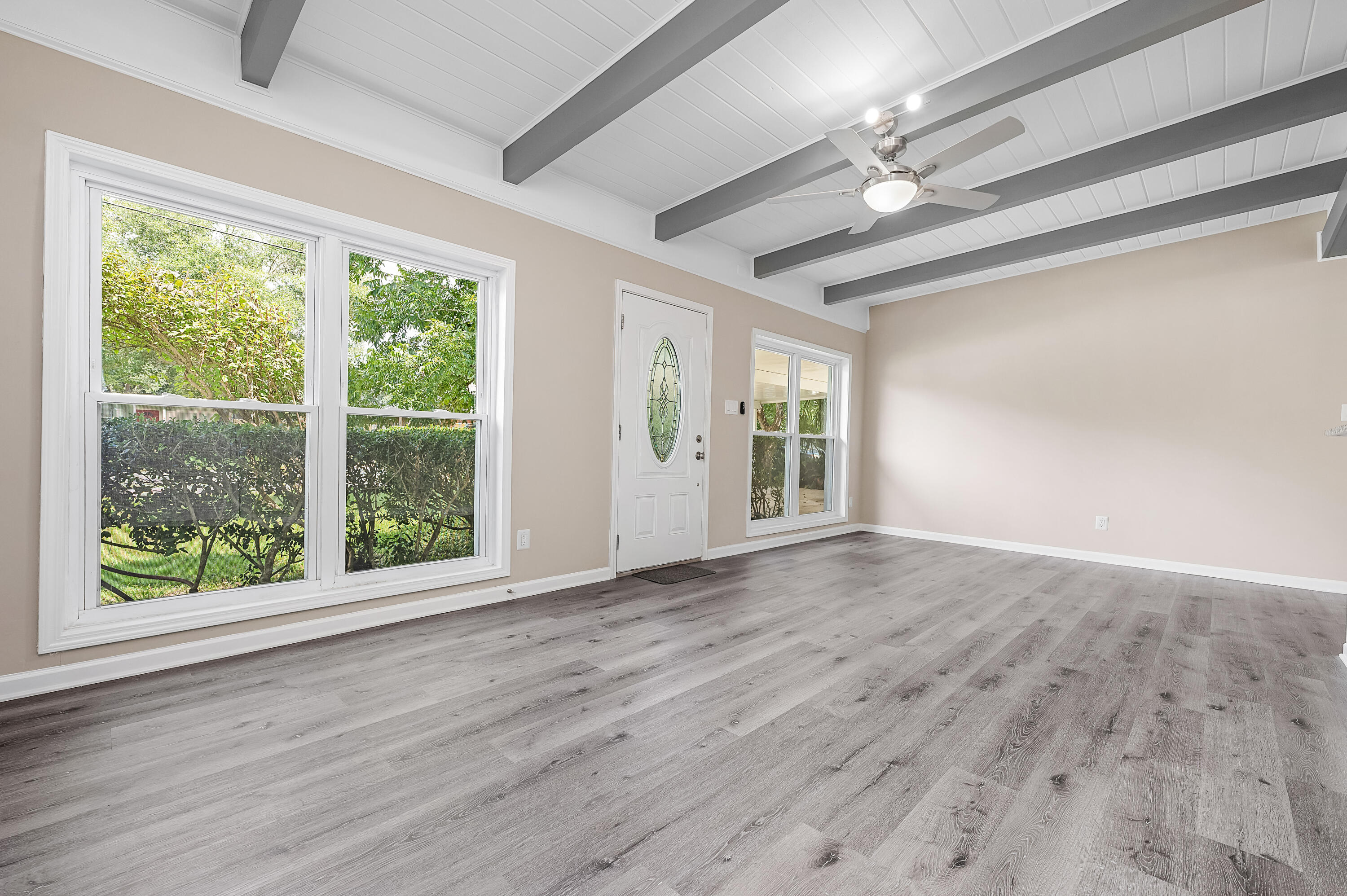 413 Gerold Street Fort Walton Beach, FL 32547 - Photo 13 of 91 a view of an empty room with wooden floor and a window