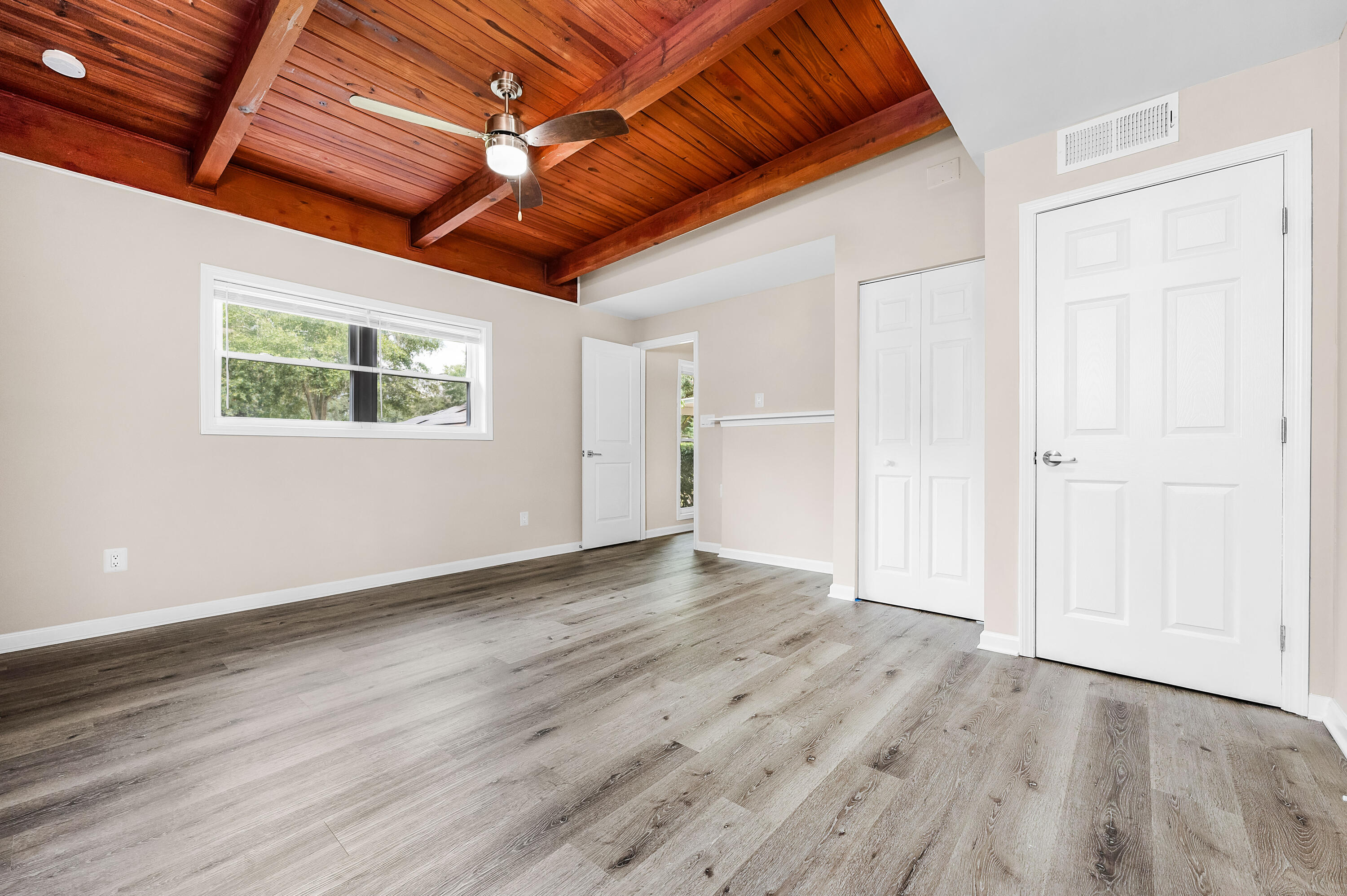 413 Gerold Street Fort Walton Beach, FL 32547 - Photo 32 of 91 a view of an empty room with wooden floor and a ceiling fan