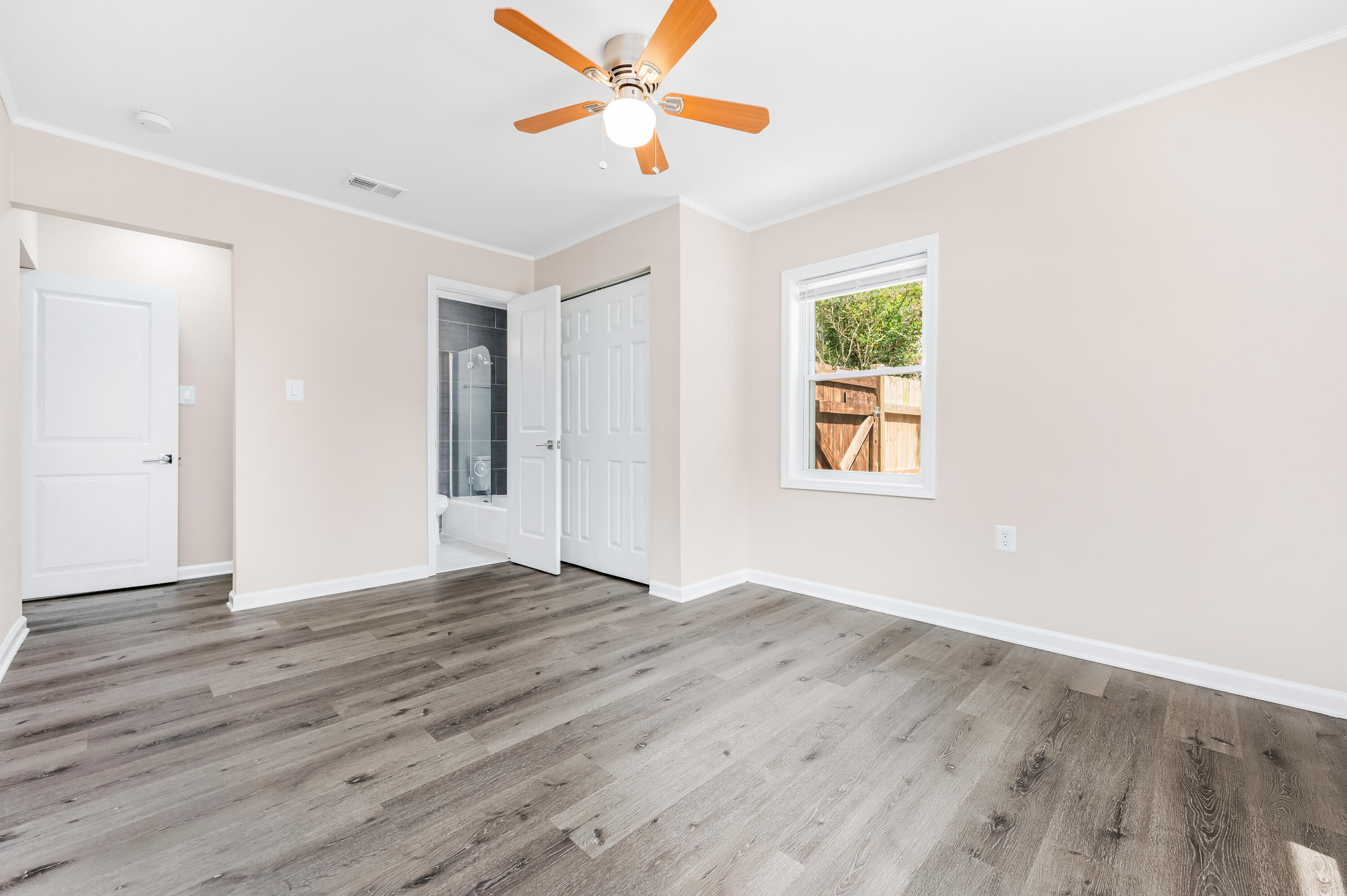 413 Gerold Street Fort Walton Beach, FL 32547 - Photo 43 of 91 a view of an empty room with window and wooden floor