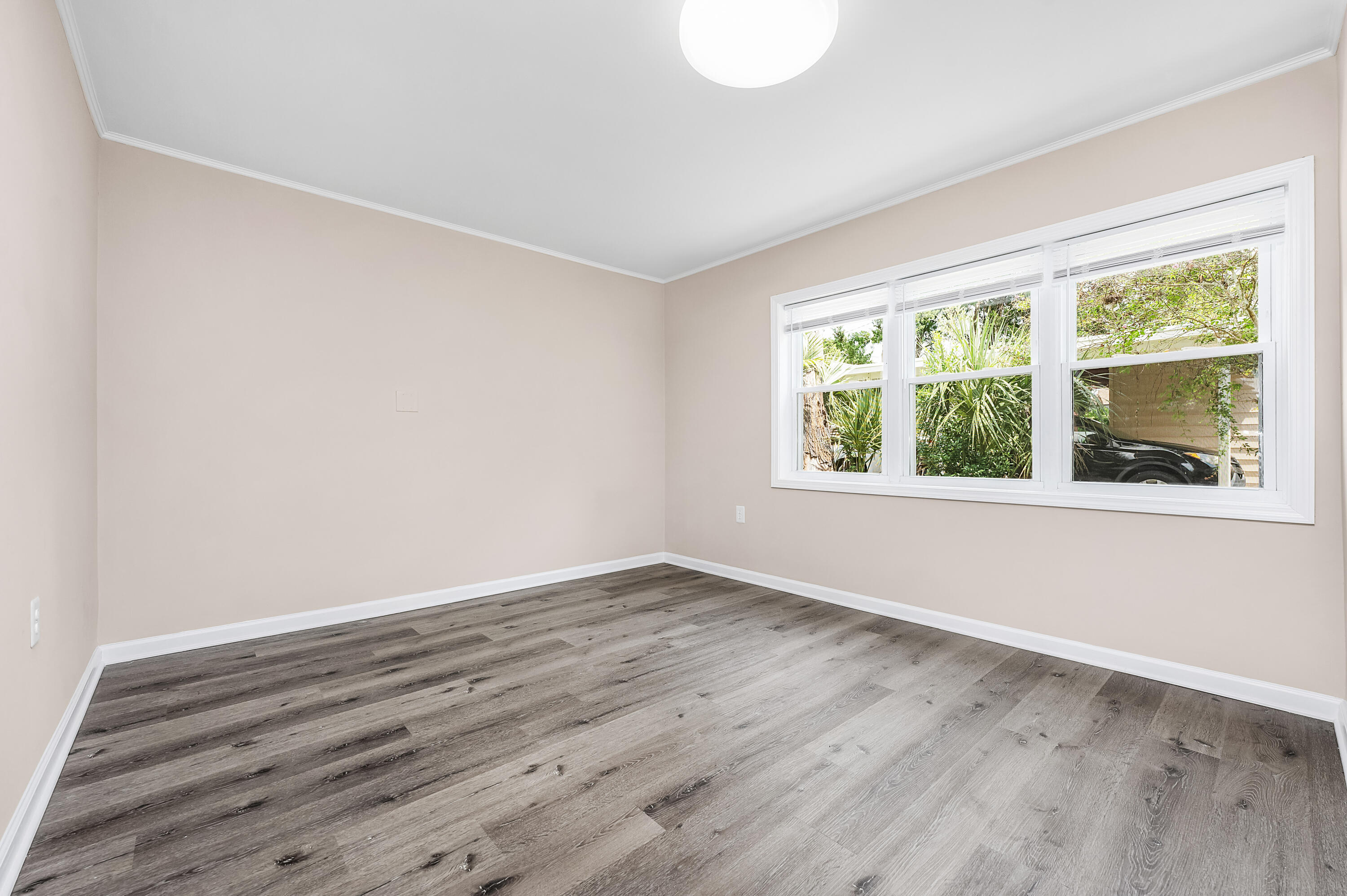 413 Gerold Street Fort Walton Beach, FL 32547 - Photo 49 of 91 an empty room with wooden floor and windows