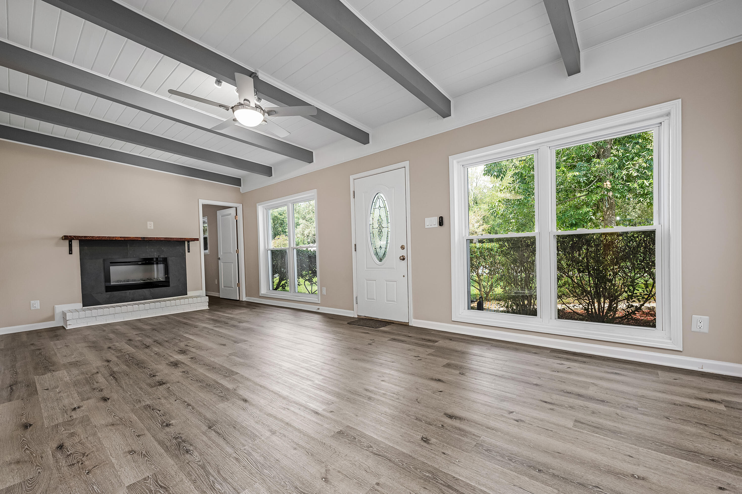 413 Gerold Street Fort Walton Beach, FL 32547 - Photo 10 of 91 a view of an empty room with wooden floor fireplace and a window