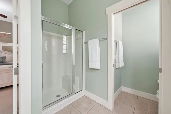 a bedroom with a bed dresser and a window