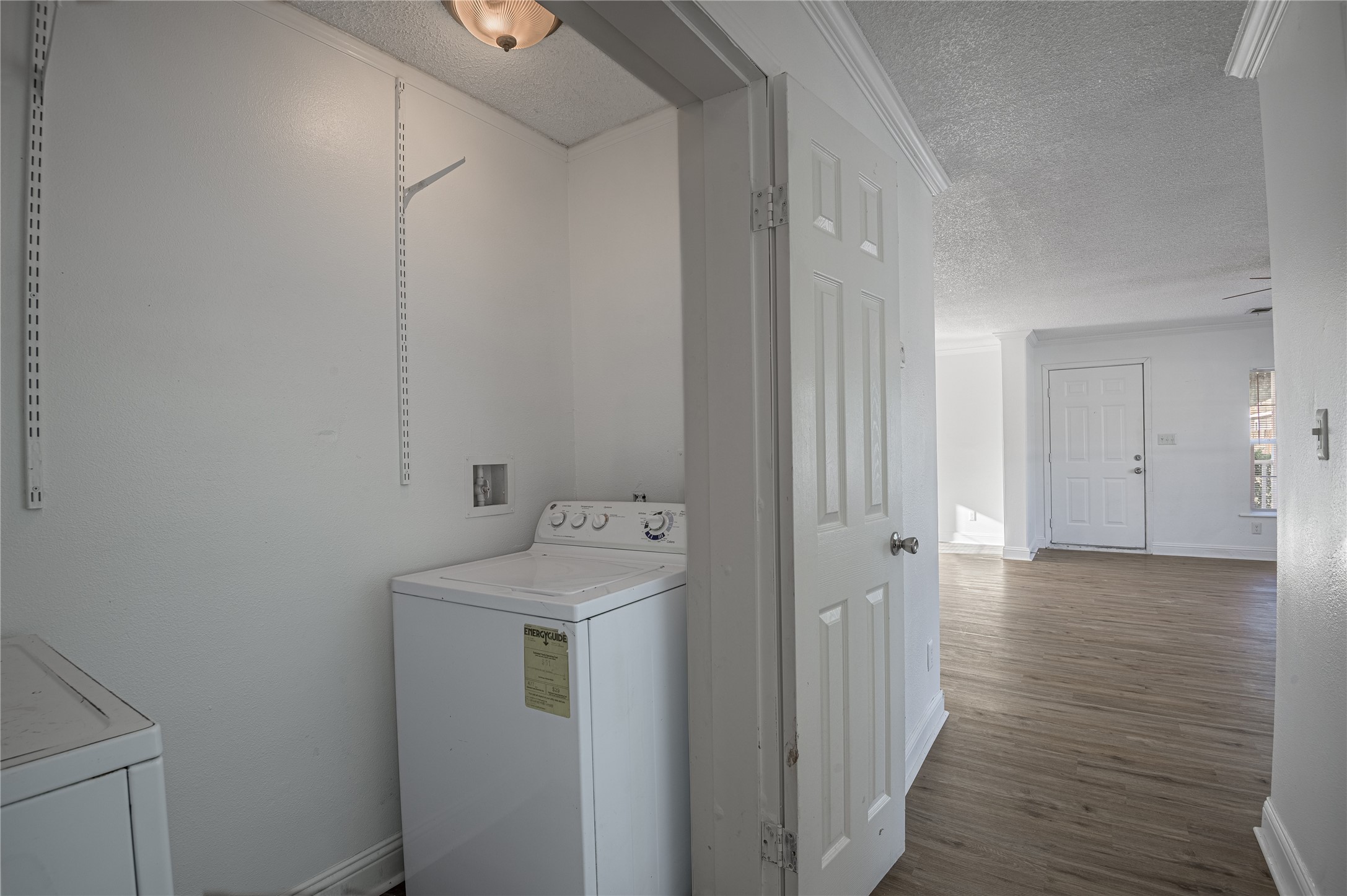 121 Varsity Circle Huntsville, TX 77340 - Photo 12 of 32 a view of a storage and utility room with wooden floor