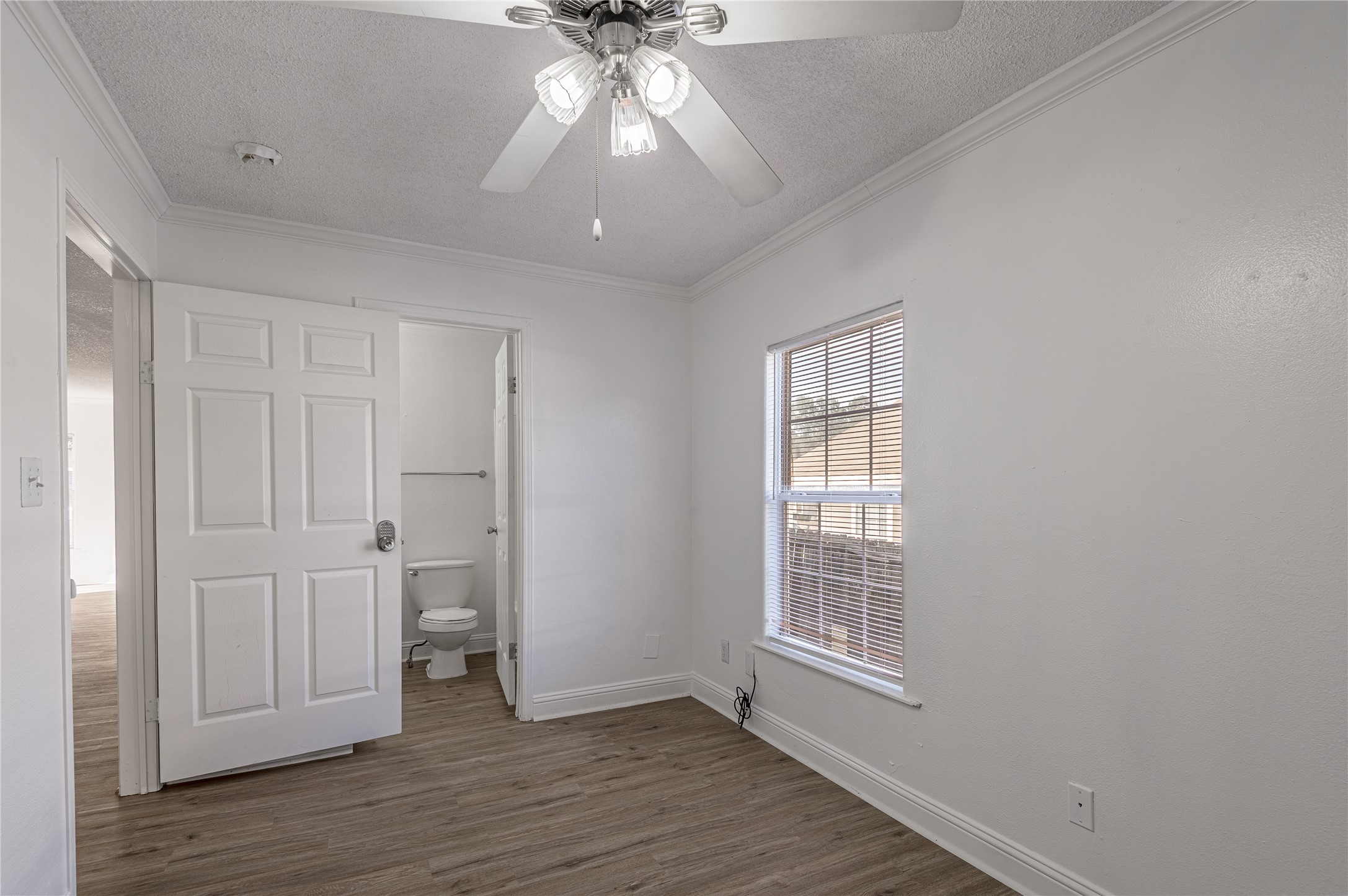 121 Varsity Circle Huntsville, TX 77340 - Photo 15 of 32 wooden floor in an empty room with a window