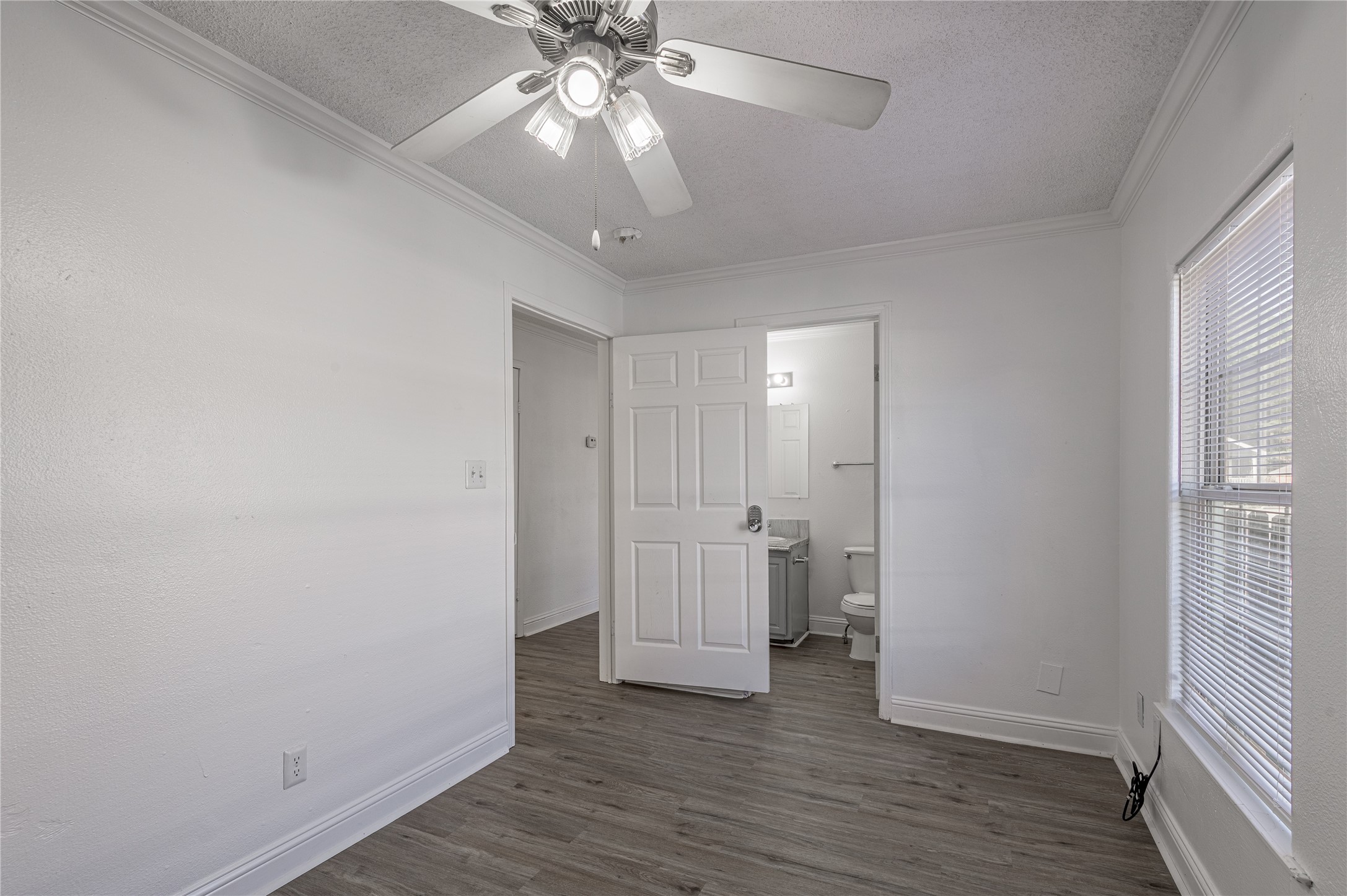 121 Varsity Circle Huntsville, TX 77340 - Photo 16 of 32 wooden floor in an empty room with a window