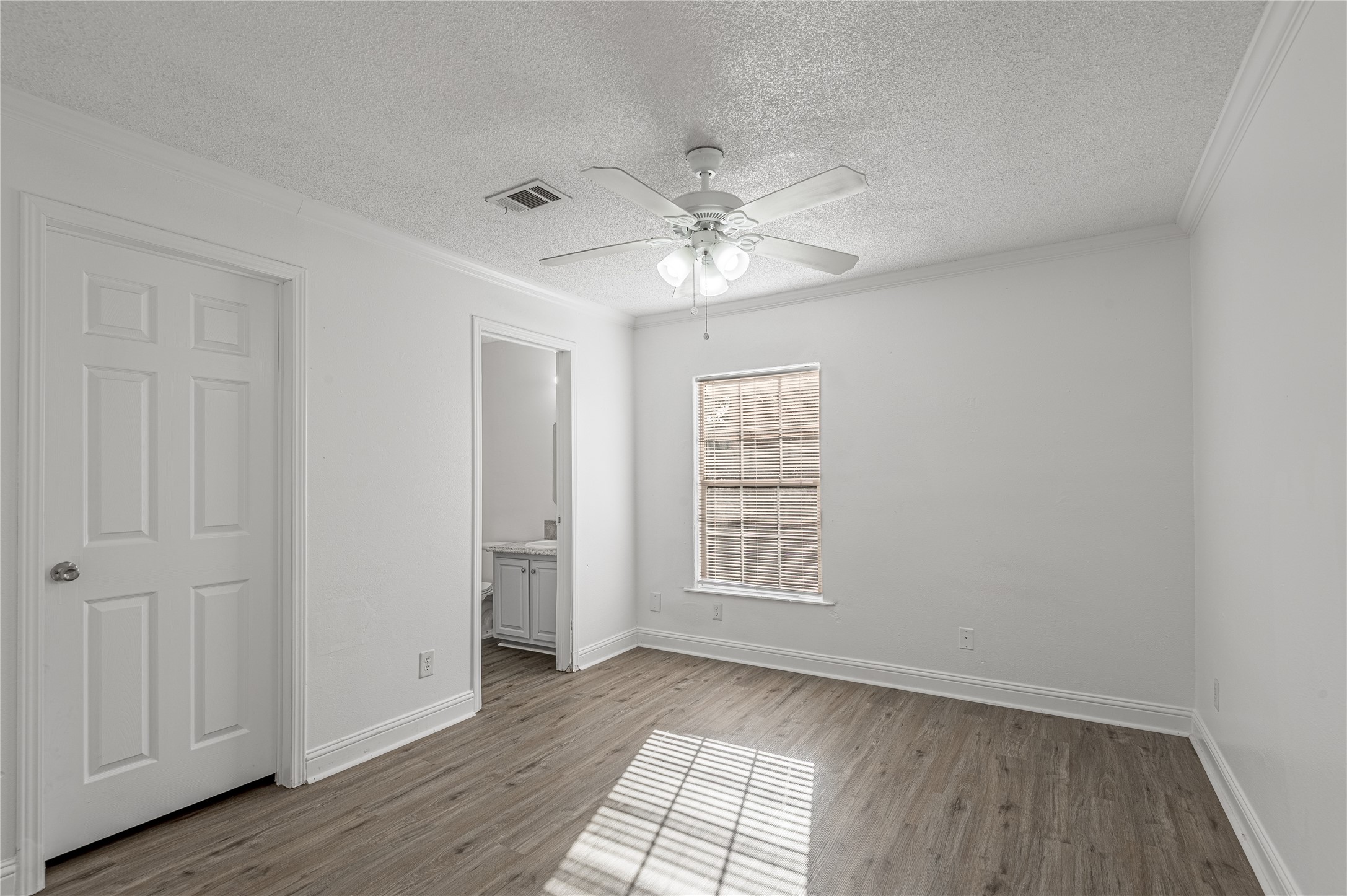 121 Varsity Circle Huntsville, TX 77340 - Photo 20 of 32 a view of an empty room with a window and wooden floor