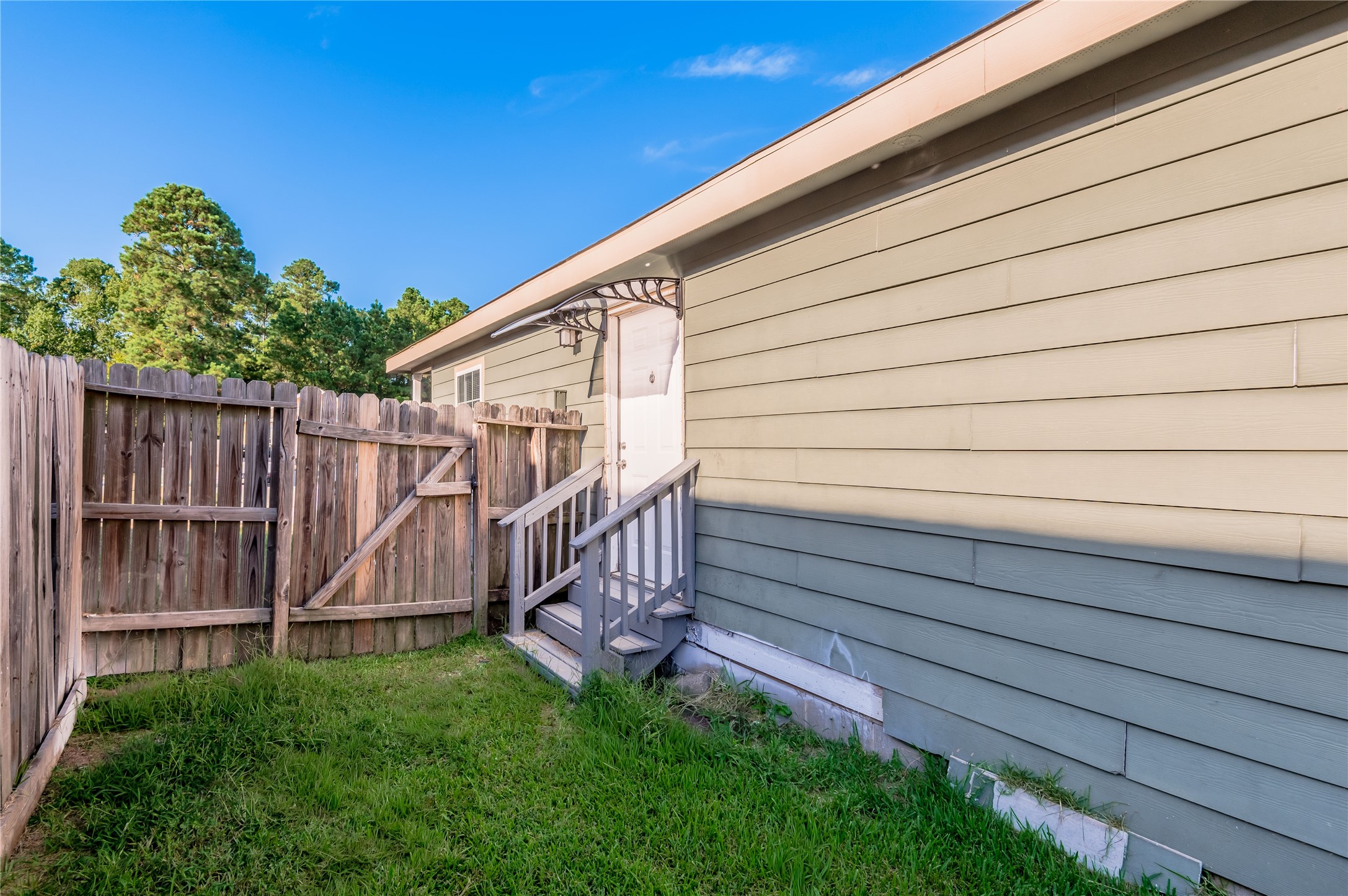 121 Varsity Circle Huntsville, TX 77340 - Photo 30 of 32 a view of a backyard with wooden fence