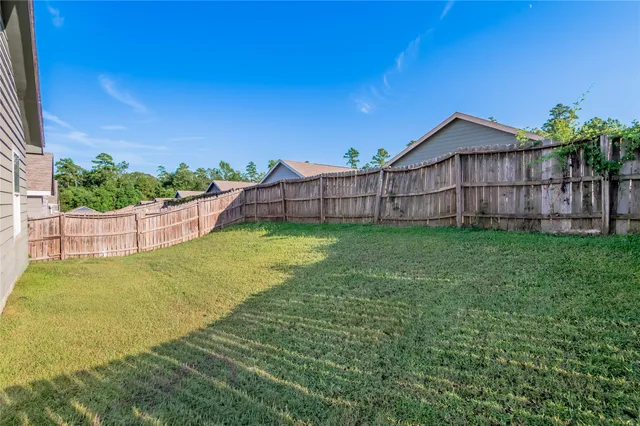a view of a backyard with a garden and deck