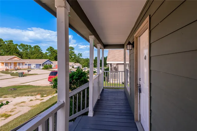 a view of a balcony with wooden floor