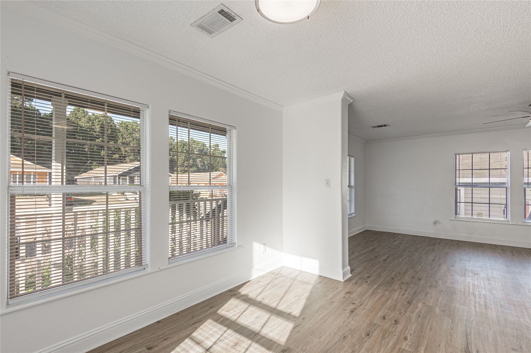 121 Varsity Circle Huntsville, TX 77340 - Photo 8 of 32 a view of an empty room with wooden floor and a window